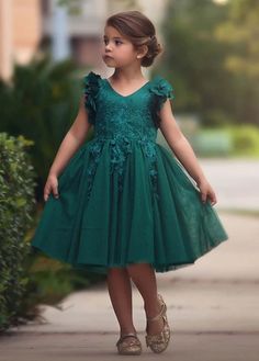 Fit for a princess, this dress has it all. Soft emerald satin graced with a touch of lace, this dress is a showstopper! Sleeves are embellished with whimsical die cut flowers that will have all eyes on her. Tulling overlay skirt adds just the right touch of fullness and twirl. Fully lined with soft cotton, back zip. 100% poly self, 100% cotton lining. Machine wash, hang dry. Flowergirls Dress, Green Toddler Dress, Trish Scully, Teal Green Dress, Girl Green Dress, Dress For Baby Girl, Bianca Dress, Long Flower Girl Dresses, Emerald Green Dress