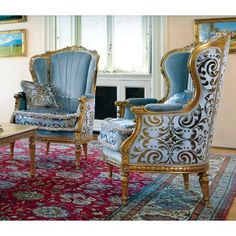 an ornately decorated living room with blue and gold chairs