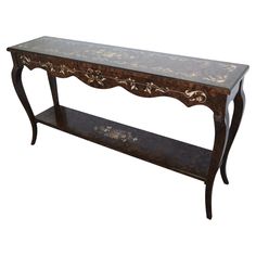 an ornately decorated console table against a white background