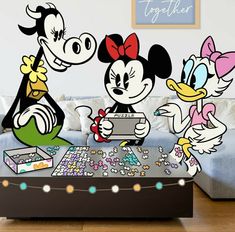 mickey and minnie mouse wall decals on a living room table with other disney characters