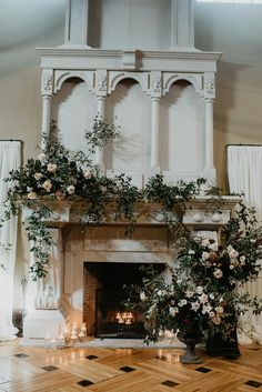 the fireplace is decorated with flowers and candles