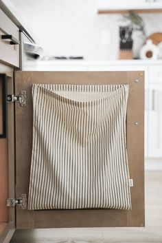 a towel hanging on the side of a cabinet in a kitchen