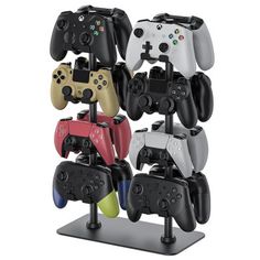 four different colored video game controllers are on display in front of a white background,