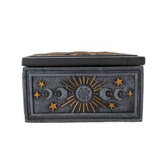 a black box with gold stars and moon designs on it's lid, sitting against a white background