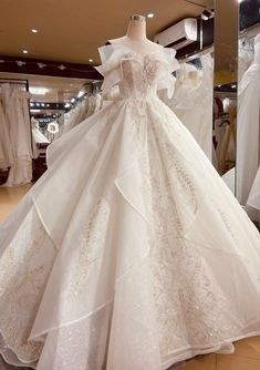 a white wedding dress on display in a store