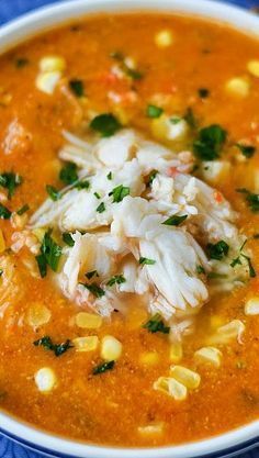 a white bowl filled with soup on top of a blue table