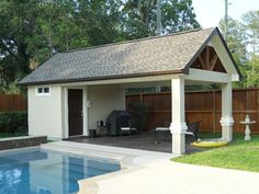 a pool house with a hot tub in the backyard