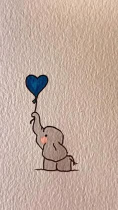 an elephant holding a blue heart shaped balloon