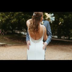 the bride and groom are standing together outside