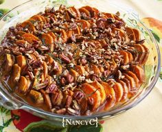 a glass dish filled with nuts on top of a table