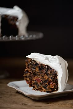 a slice of carrot cake with white frosting on a plate