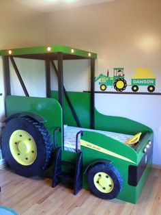 a child's bed made to look like a tractor