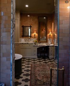 a bathroom with black and white checkered flooring, two lights on either side of the bathtub