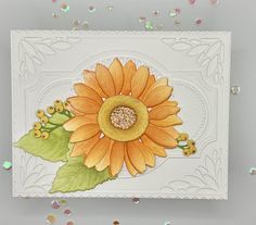 a card with an orange sunflower on it