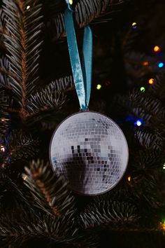 a disco ball ornament hanging from a christmas tree