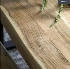 a close up of a wooden table with plants on it