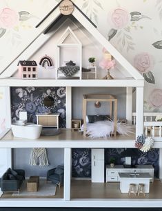 a doll house with furniture and accessories on the top floor, in front of a wallpapered background