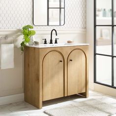 a bathroom with a sink, mirror and towel rack