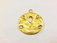 This vermeil sand dollar charm measures about 18mm in diameter. It is perfect for bracelet, necklace and earrings. It is 18k gold plated over 925 sterling silver (vermeil), shiny gold. 925 stamped in the back. 1 pc. silver version: Listing: http://www.etsy.com/listing/114478741/925-sterling-silver-oxidized-sand-dollar matte vermeil version: Listing: http://www.etsy.com/listing/150706144/vermeil18k-gold-over-925-sterling-silver For the larger quantity convo us. Thanks for stopping by! Tarnish Resistant Gold Beach Jewelry, Tarnish Resistant Gold Jewelry For Beach, Gold Medallion Charms With Coin Pendant, Gold Round Beach Jewelry, Gold Round Jewelry For Beach, Gold Round Jewelry For The Beach, Gold Pendant Jewelry With Starfish Charm, Gold Coin Pendant Charms, Gold Round Pendant Jewelry For The Beach