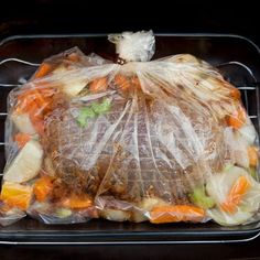 a plastic bag filled with food sitting on top of an oven