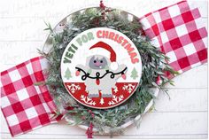 a christmas ornament on top of a red and white checkered table cloth