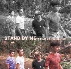 three young boys standing next to each other in front of trees and the words stand by me