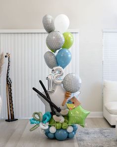 a birthday decoration with balloons and scissors