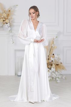 Bridal robe for bride with Train for the Perfect Wedding Morning!Luxury robe for women for wedding moning! Get ready for your big day in this exquisite bridal lace wedding robe with train. Made from delicate lace and featuring a stunning train, this robe is the perfect choice for any bride's wedding morning.  Long bridal robe with train  and Delicate Bridal Lace Details!  Bride Maxi robe  for Your Wedding Day! Make your wedding day even more special with this floor-length white bridal robe. Feat Elegant Long Sleeve Wedding Dress With Sweep Train, Satin Wedding Dress With Sweep Train, Satin Gown With Sweep Train For Wedding, Full Length Satin Wedding Gown, Full-length Satin Wedding Gown, Wedding Satin Full-length Gown, V-neck Wedding Gown With Sweep Train, Full Length Wedding Gown With Sweep Train, Long Satin Evening Gown