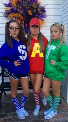 three girls in matching outfits posing for the camera