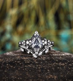 a diamond ring sitting on top of a rock