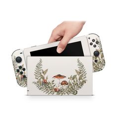 the nintendo wii game console is being held up by someone's hand and holding it