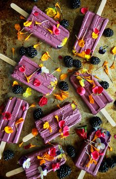 several popsicles with fruit and flowers on them