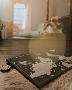 a map laying on the floor in front of a mirror