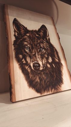 a painting of a wolf on a wood paneled shelf in a room with white walls