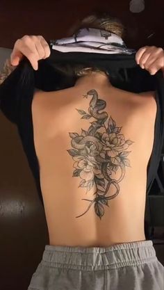 the back of a woman's body with flowers on it