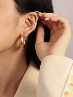 Take a risk with our Clara Earrings! These bold hoop earrings make a statement for every occasion. Lightweight and daring, these earrings are the perfect accessory for any adventure! …………………………………. D E T A I L S• Materials: Stainless steel, 18k gold plating.• Hoop Diameter: 3 cm (1.2 inches) • Width: 1 cm (0.7 inches)• Length: 3 cm (1.2 inches)• This product is hypoallergenic, water and tarnish resistant Polished Finish Hoop Earrings, Luxury Everyday Small Hoop Earrings, Luxury Tarnish Resistant Huggie Earrings, Timeless Small Hoop Earrings For Pierced Ears, Luxury Clip-on Earrings With Plating, Luxury Round Everyday Earrings, Timeless Hoop Earrings For Gifts, Timeless Hoop Earrings Gift, Timeless Hoop Earrings As Gift