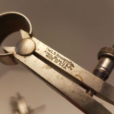 an old pair of scissors is being held up