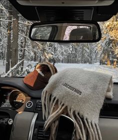 the interior of a car with two hats and a scarf on it's dash board