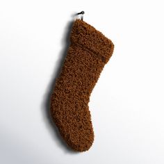 a brown stocking hanging on a white wall