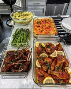 several trays filled with different types of food on top of a kitchen countertop