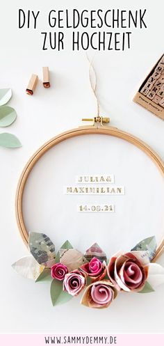 an embroidery hoop with flowers on it and the words, diy geldgeschenk