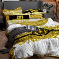 a bed with yellow and black comforters on top of it