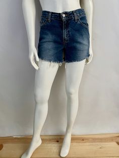 "Vintage Women's 90's Levi's 517, High Waisted, Cut Off's, Denim, Shorts (S) 669 These Ladies Shorts come in a medium blue colored wash cotton and have three front pockets, two back pockets and are high waisted with belt loops, front button closure with signature Levi's red tab logo and fringe front. 100% Cotton Made in Guatemala *These shorts are in excellent condition. Size: (S) Modern Day 4 (Tag Size: 5 jr M) Waist: 30\" Length: 12 1/2\" (unfolded) Hips: 34\" Rise: 10\" (front) 13\" (back) In Casual Dark Wash Bottoms With Frayed Hem, Medium Wash Bottoms With Frayed Hem In Short Length, Medium Wash Short Bottoms With Frayed Hem, Short Length Bottoms With Frayed Hem In Medium Wash, Dark Wash Bottoms With Frayed Hem, Dark Wash Short Bottoms With Frayed Hem, Dark Wash Frayed Hem Shorts, Medium Wash Short Leg Bottoms With Frayed Hem, Medium Wash Bottoms With Frayed Hem And Short Leg