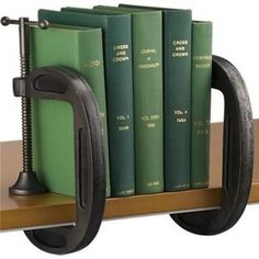 a book shelf with several books and a phone on it's holder, which is attached to the wall