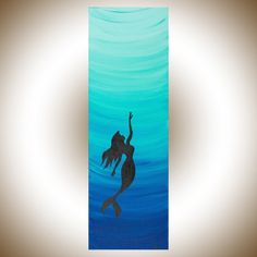 a painting of a mermaid swimming in the ocean