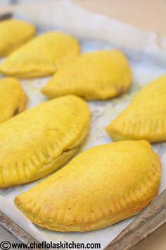 several pastries on a baking sheet ready to be baked in the oven for consumption