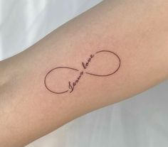 a woman's arm with the word love written in cursive handwriting