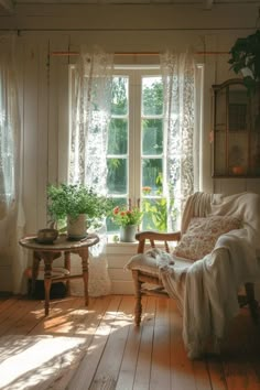 the sun shines through two windows into a room with white walls and wood floors