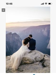 a bride and groom sitting on top of a mountain