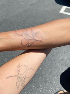 two people with tattoos on their arms